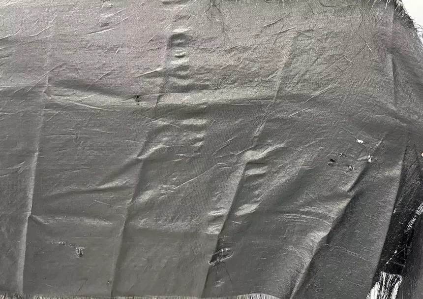 A tarp filled with bullet holes.