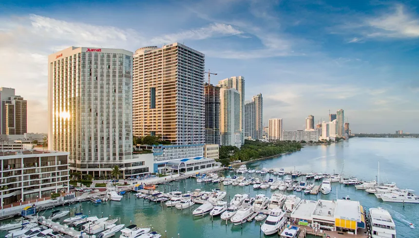 Condominium buildings along the water and a boat marina