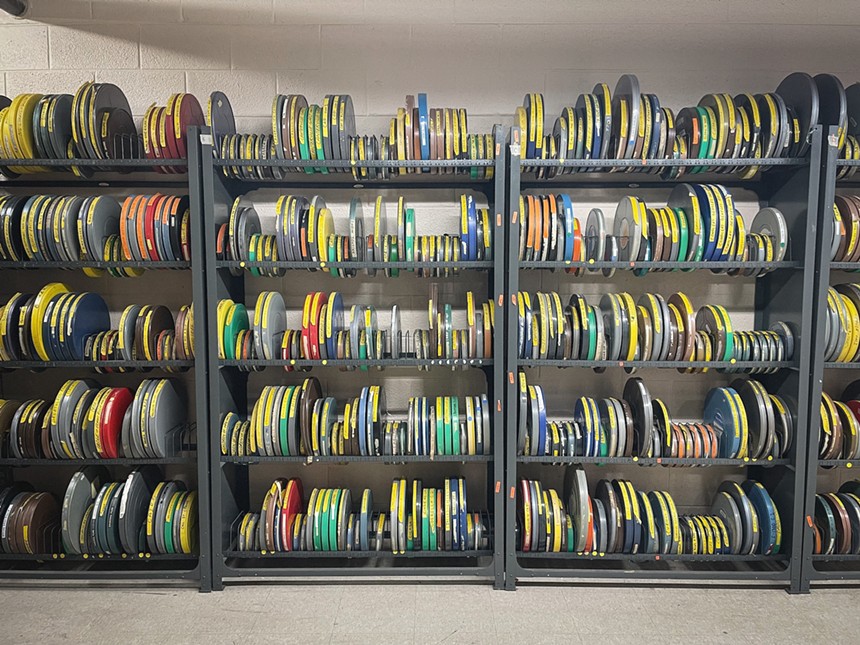 Reel of film stacked vertically on a shelf