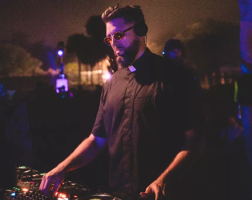 Tchami spinning music behind the decks