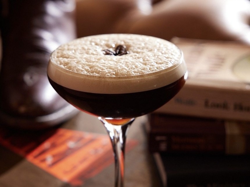 A frothy brown cocktail in a glass
