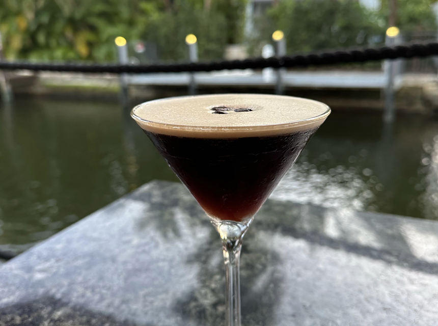 A dark brown cocktail in a glass