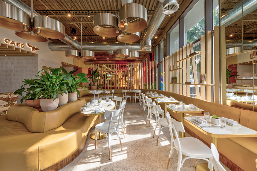 A dining room with tables and lighting fixtures