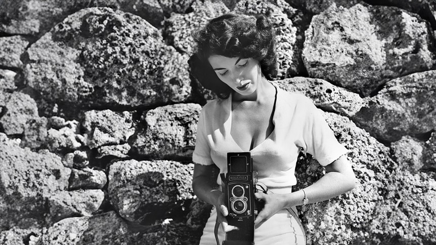 Bunny Yeager holding a camera