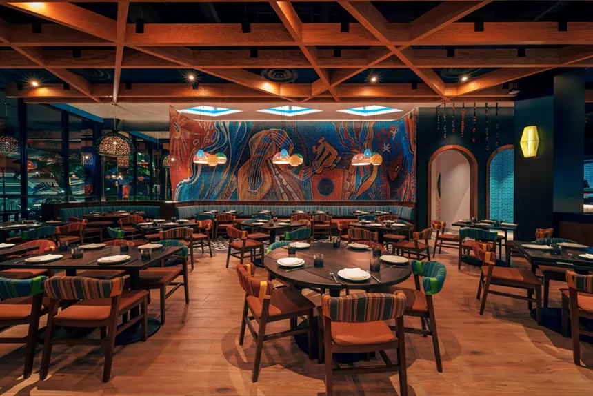 A dark dining room with wood elements