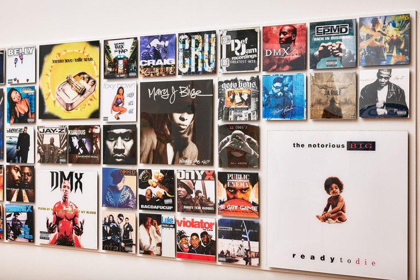 Hip-hop album covers hanging on a gallery wall