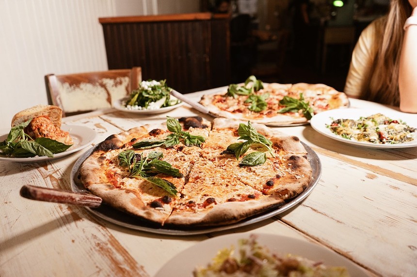 Pizzas on a wooden table