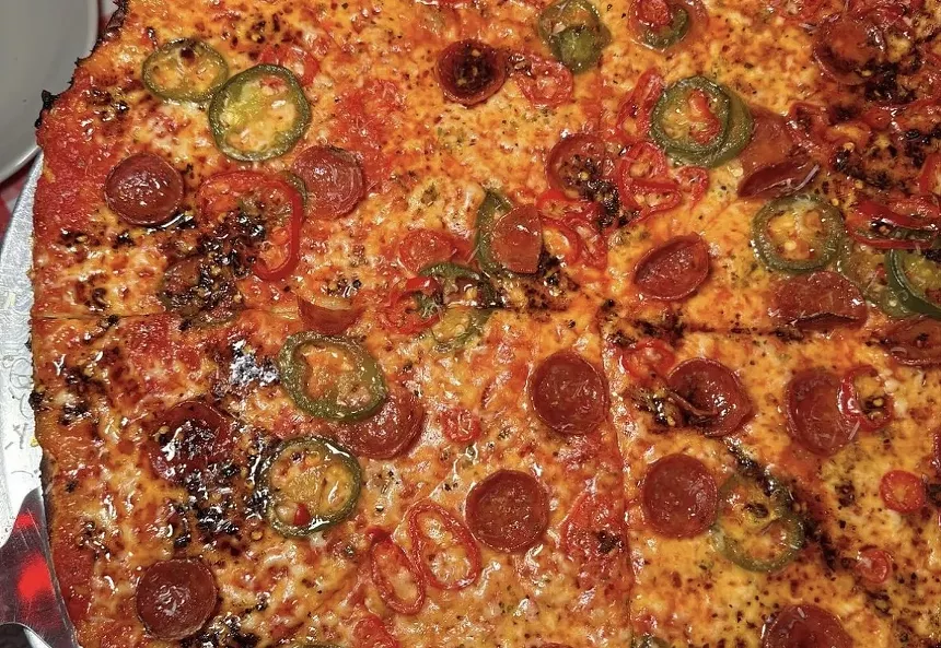 A pizza with pepperoni toppings