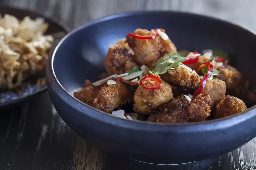 A chicken dish in a blue bowl