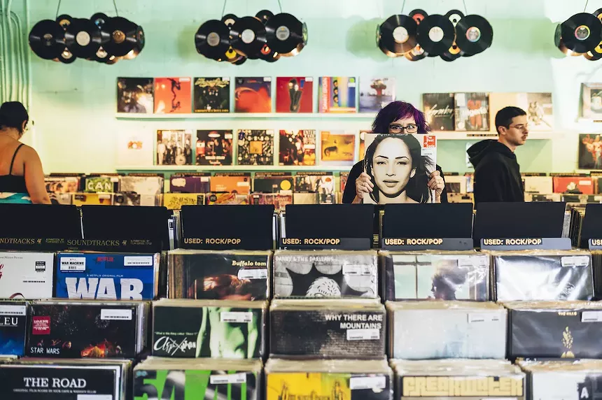 Rows of vinyls organized in racks at Sweat Records