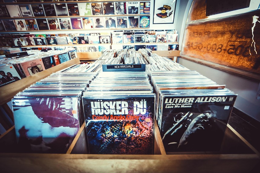 Rows of vinyls in bins at Technique Records