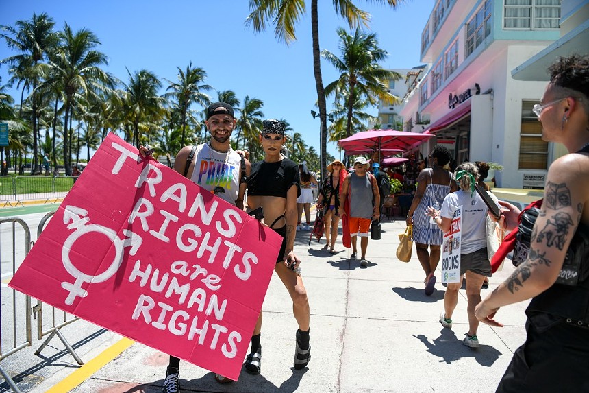 Two people holding a sign that reads, "Trans rights are human rights"