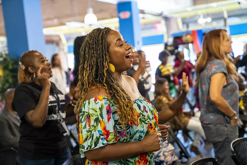 Woman in the crowd singing along