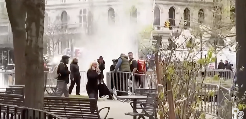 A stunned crowd in a New York City park after a man set himself on fire