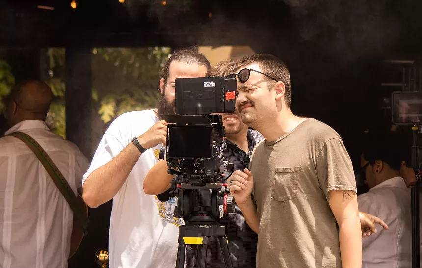 Chris Molina is looking through a camera