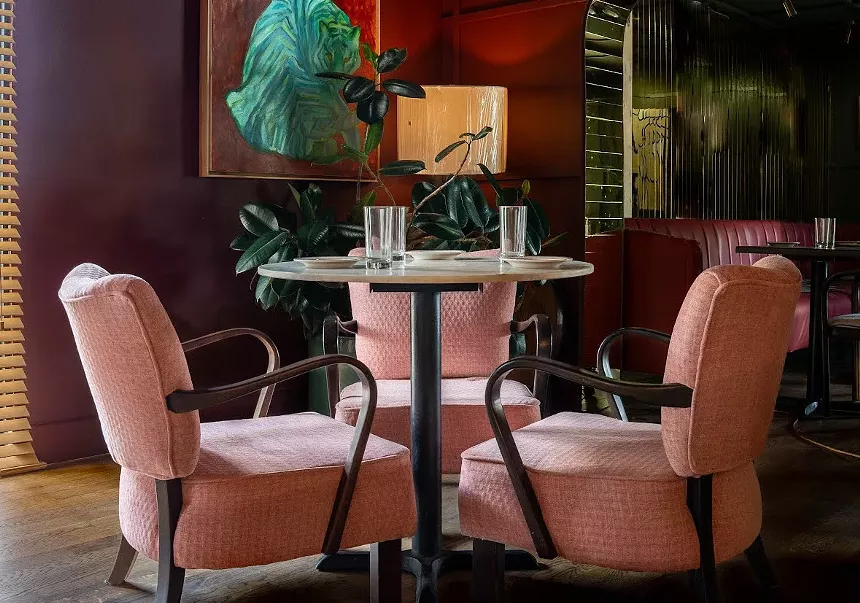 Two pink chairs and a table
