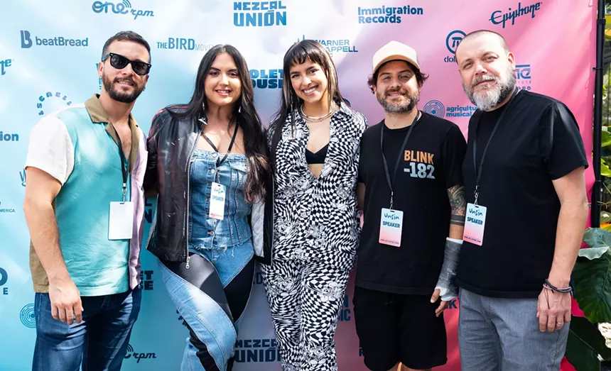 Five people lined up and posing for the camera