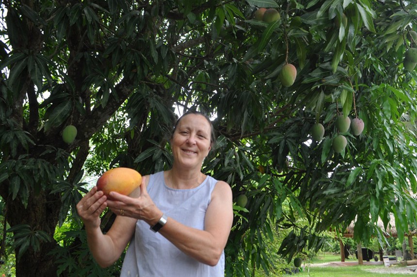 A woman holding a mango