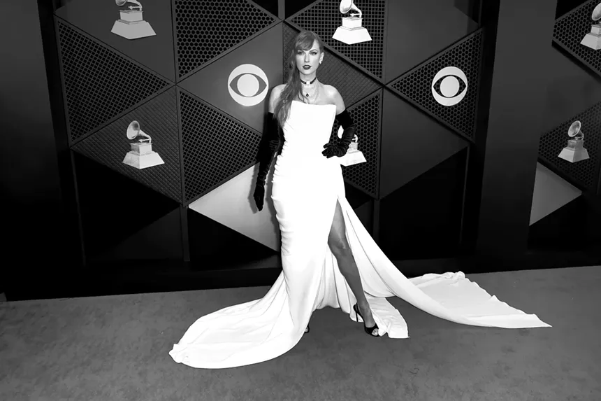 Taylor Swift in a white dress on the red carpet of the Grammys