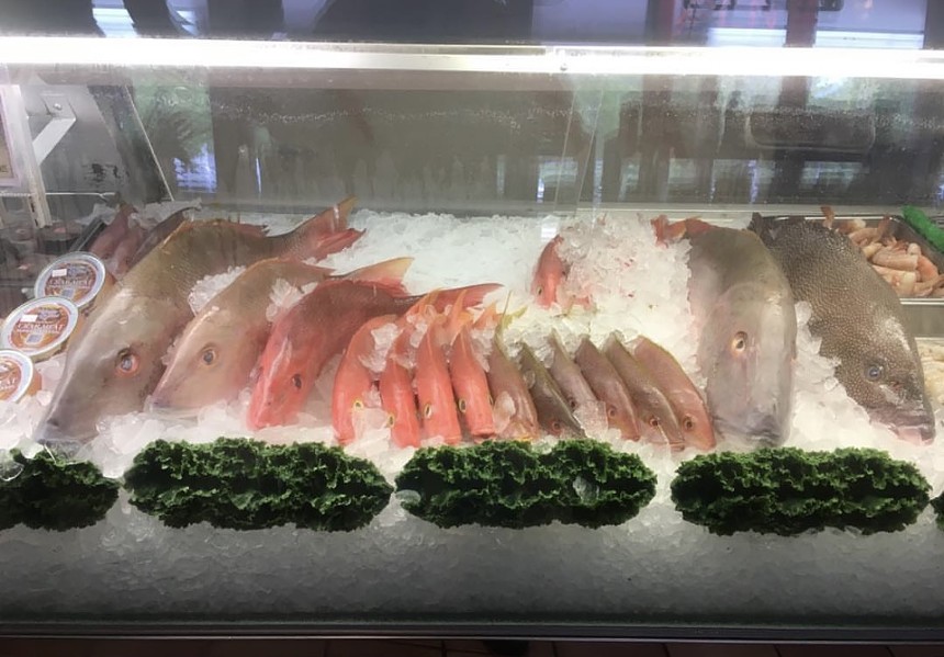 A row of seafood in a glass container