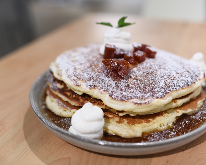 Pancakes with powdered sugar and guava paste on plate