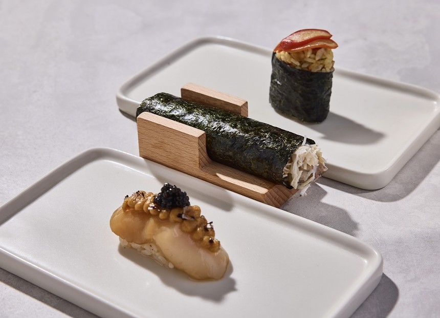 Sushi with seaweed wrappers on a white plate