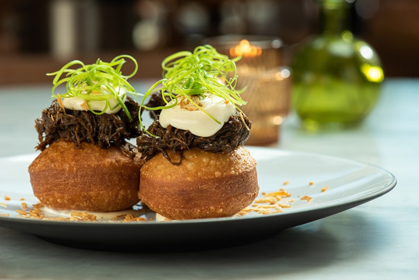 Pastry puffs with toppings on white plate