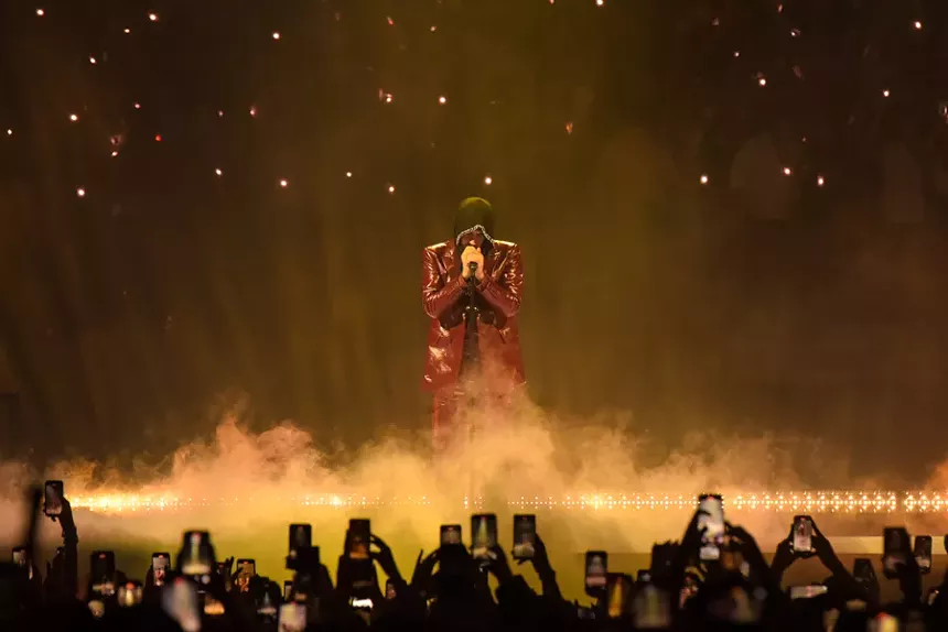 Bad Bunny performing on stage at the Kaseya Center