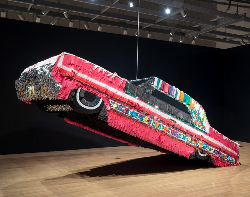 Installation of a car decorated as a piñata by Justin Favela