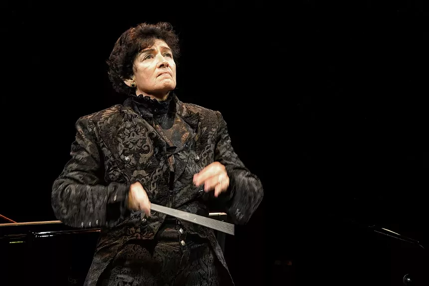 Maestra Sebrina Alfonso conducting the orchestra on stage