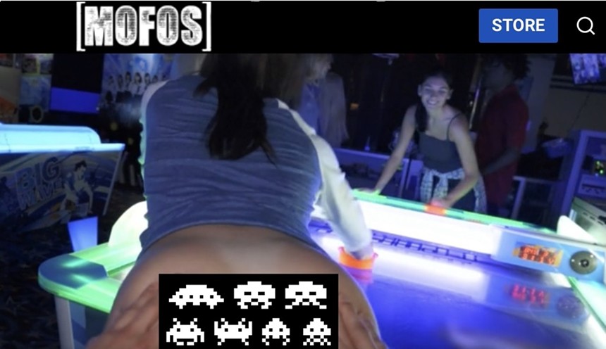 A porno being shot around an air hockey table at a Miami-area arcade