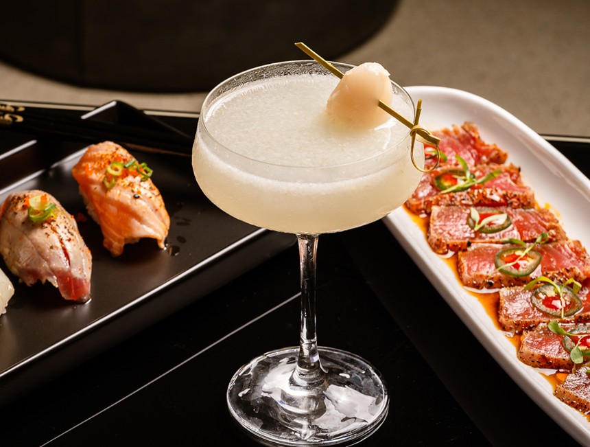 Sushi rolls on white plates and a lychee martini