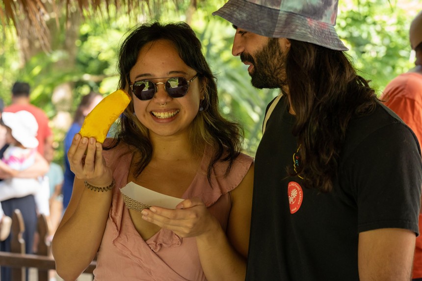 two people eating mango
