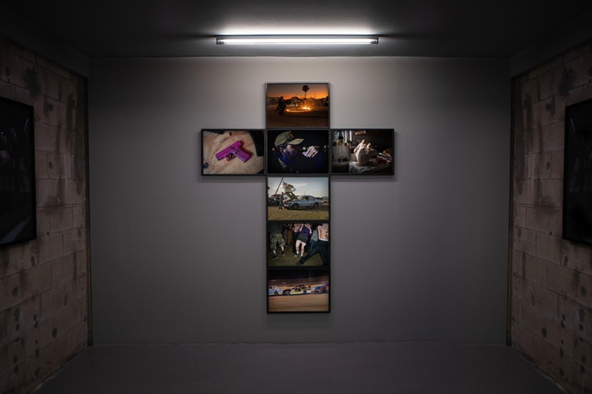 Photo hung in the shape of a cross on a gallery wall