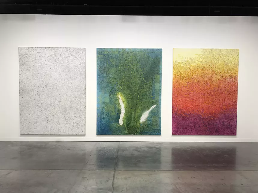 Three painting on canvas hanging on a white wall