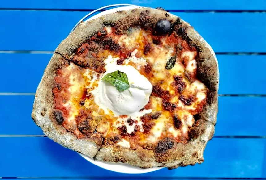 a pizza on a blue table