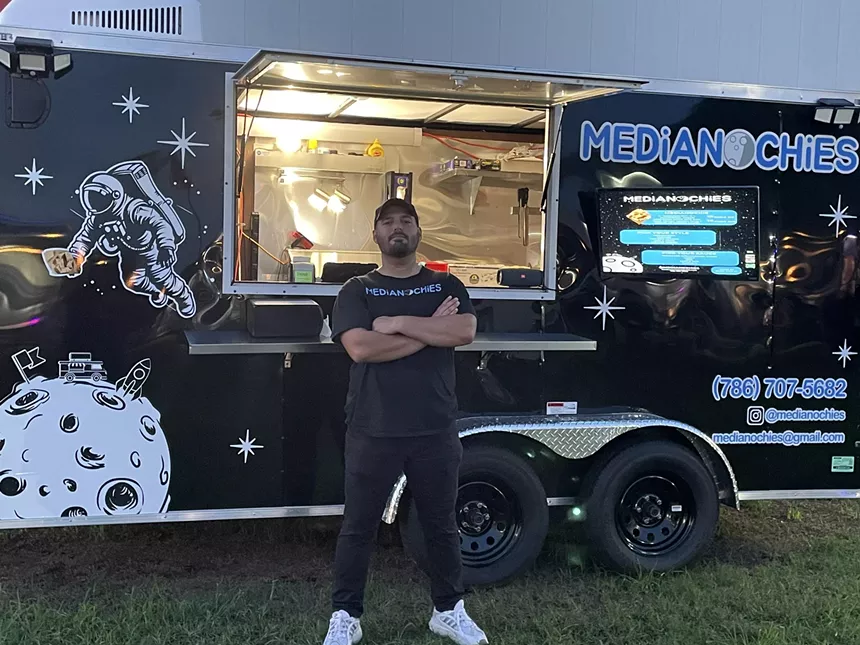 a man in front of a truck