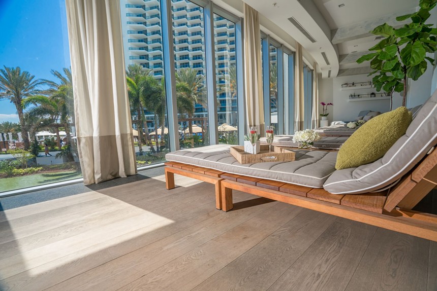 Lounge chairs facing large floor-to-ceiling windows