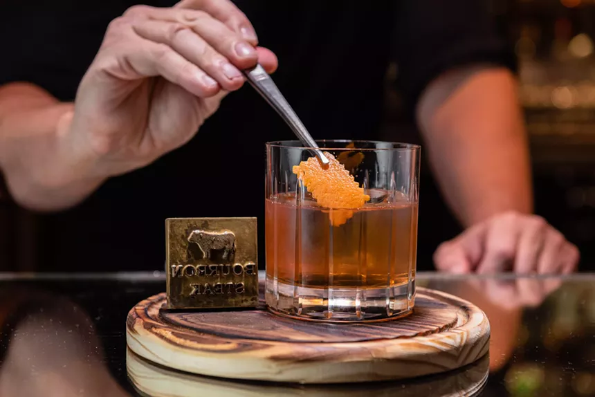 a man serving a cocktail.