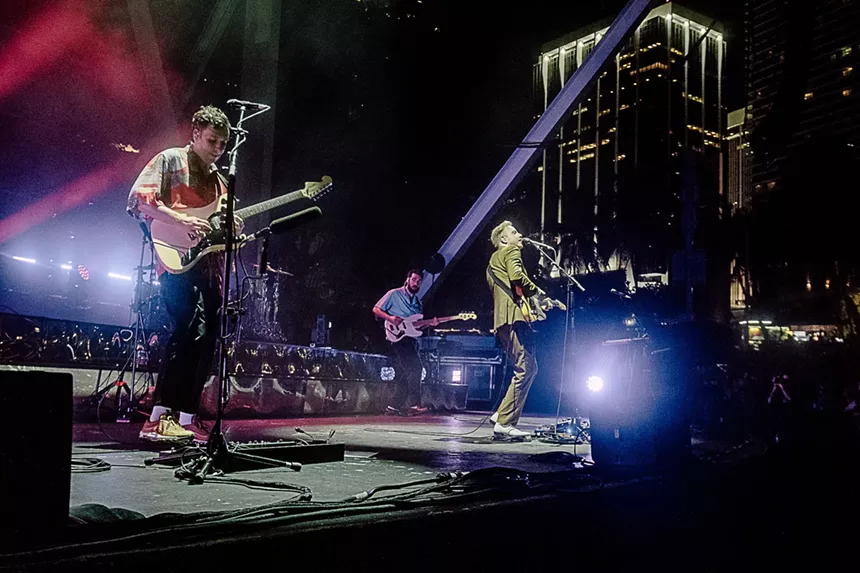 Two Door Cinema Club performing onstage at the FPL Solar Amphitheater