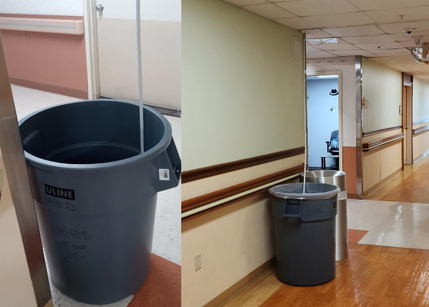 A veterans hospital routing water from roof leaks into trash cans in a hallway