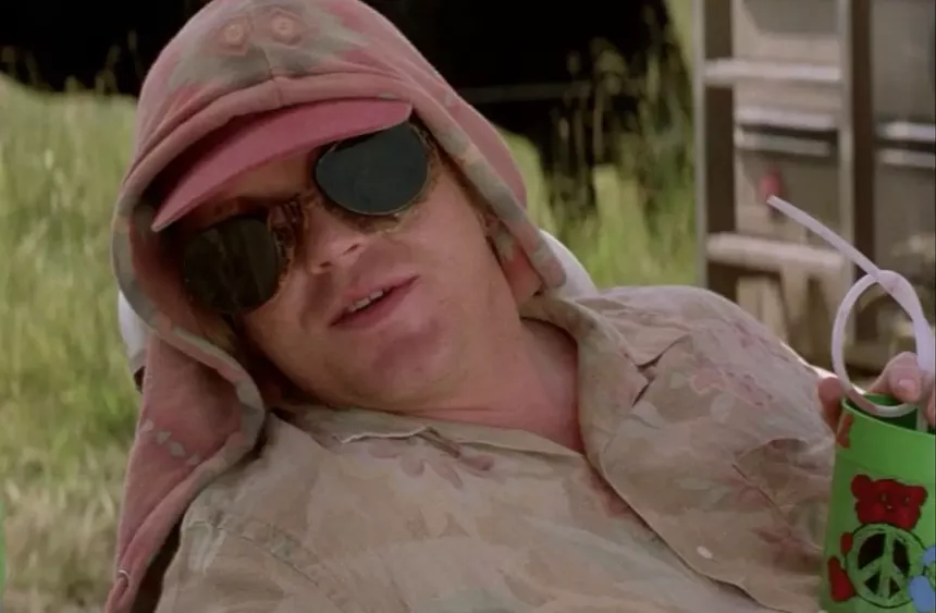 29-year-old Philip Seymour Hoffman in shades and hoodie, chillin' with a peace sign-adorned plastic cup equipped with a twisty straw