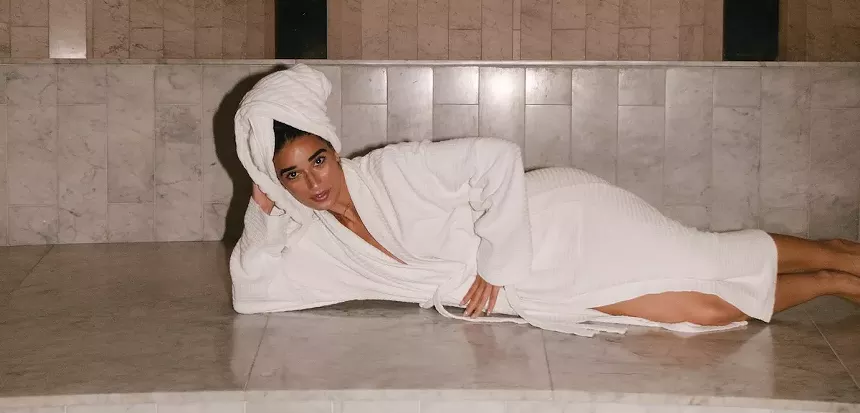 A woman laying down in a robe