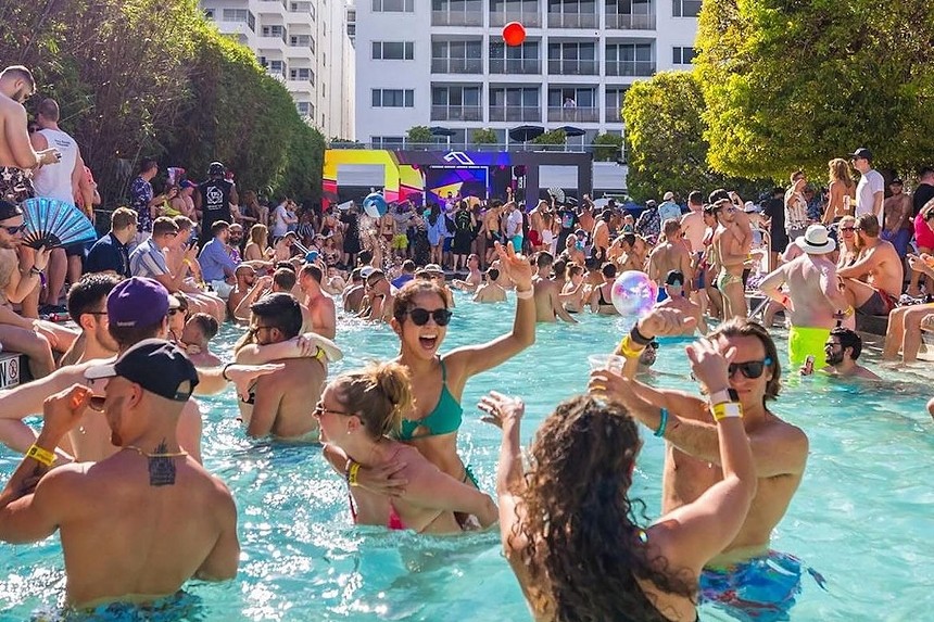 People partying around the pool at Nautilus Sonesta Miami Beach