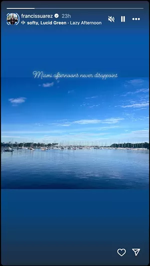 an instagram story showing a placid Miami marina scene with sailboats at anchor on calm waters and a city skyline in the distance