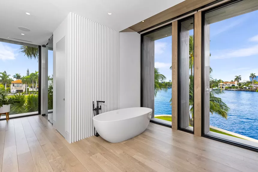 bathtub in the primary suite next to floor-to-ceiling windows