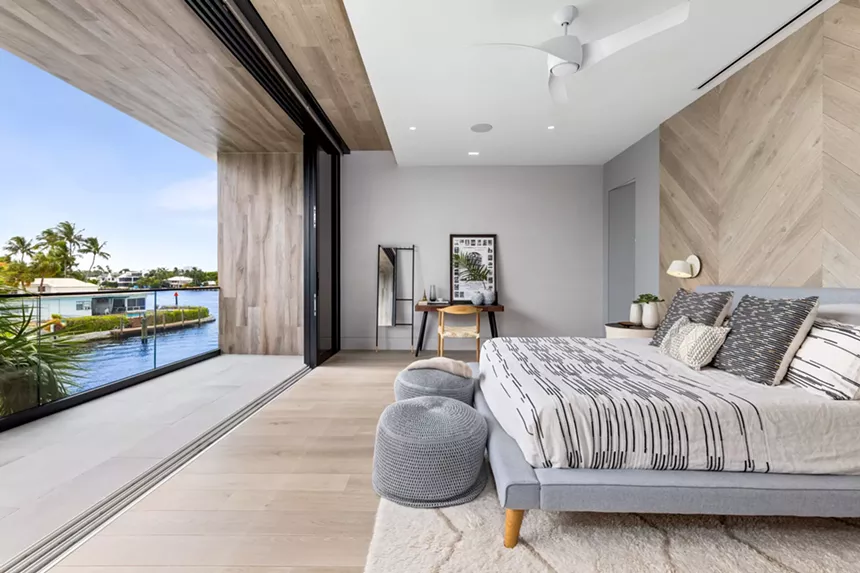 bedroom with the sliding glass doors open to the balcony
