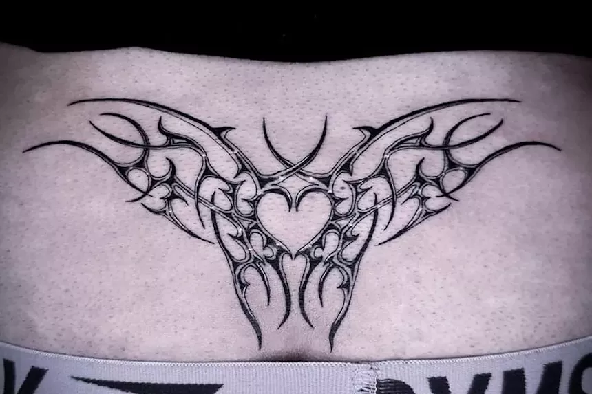 A lower back tattoo in a cybersigilism style