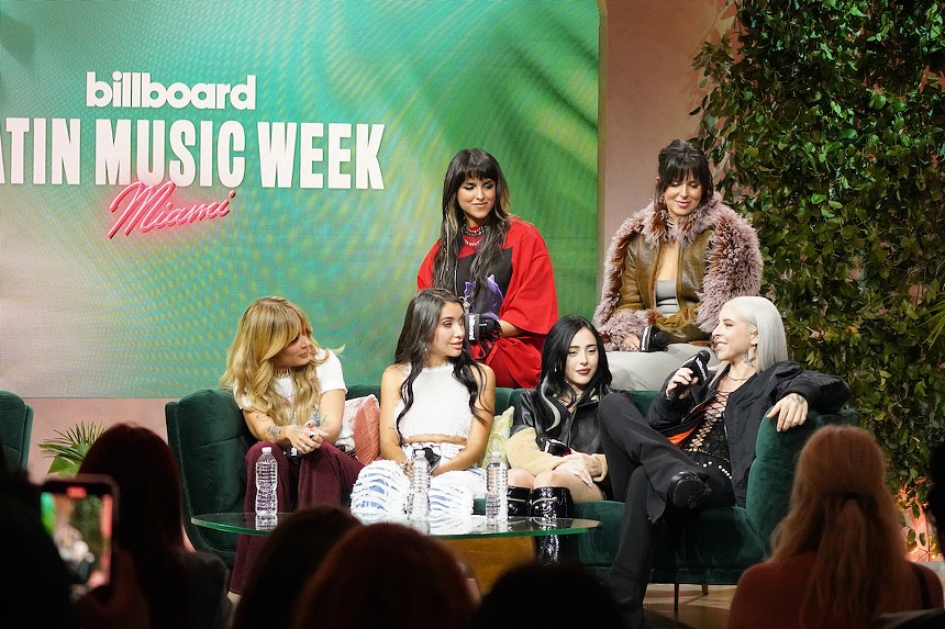 Young Miko speaking at a Billboard Latin Music Week 2023 panel.