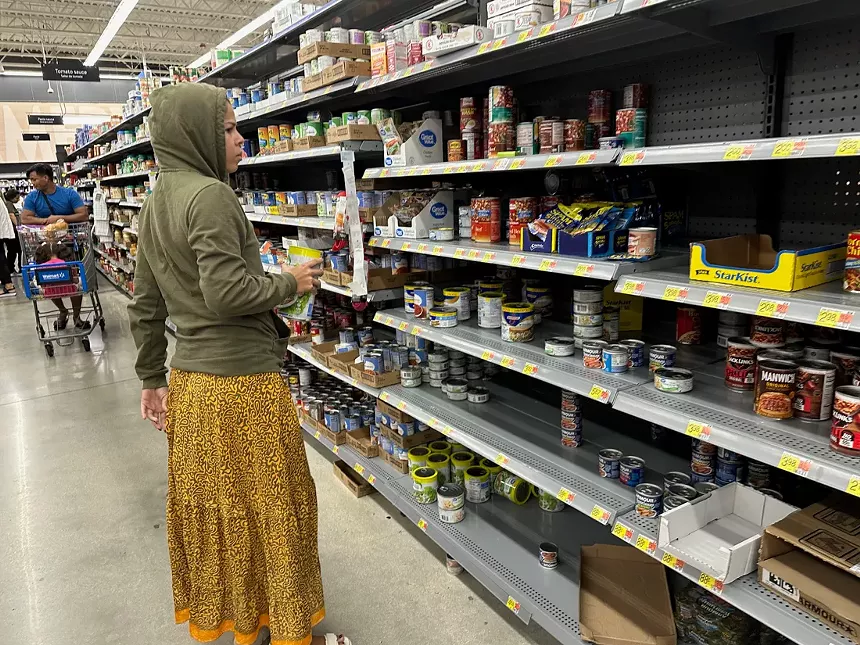Half empty shelves of canned goods at Walmart